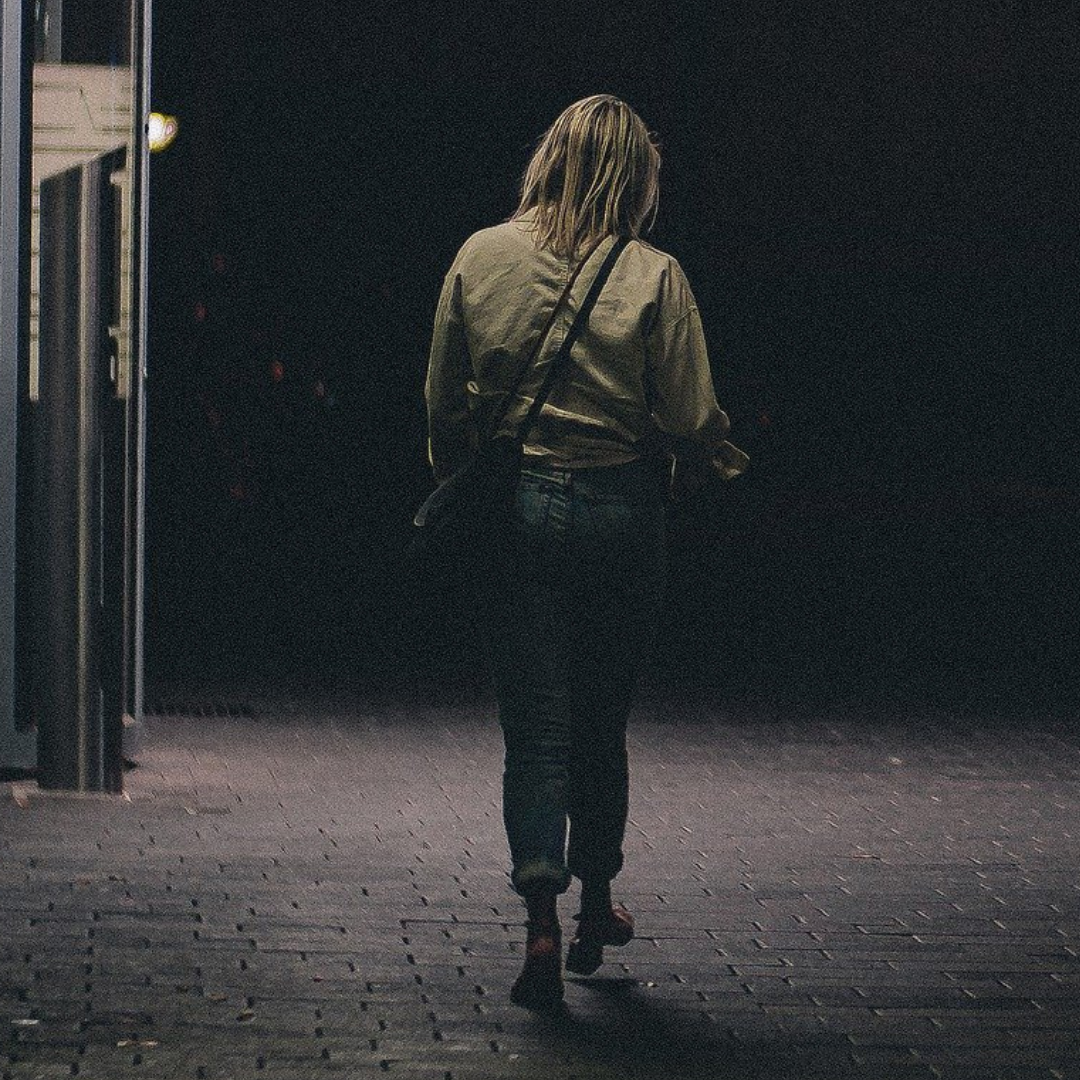 A woman walking alone at night