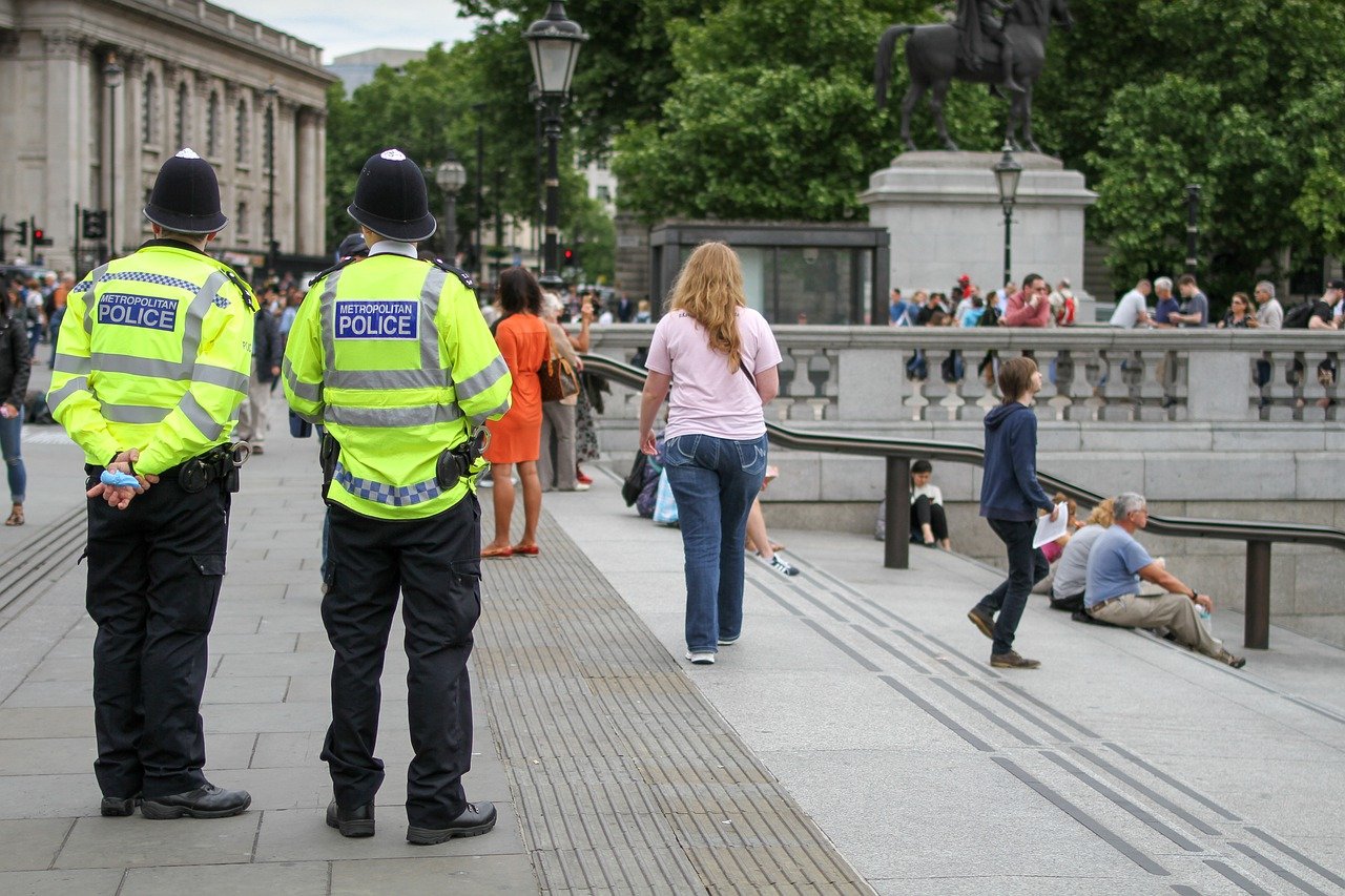 Two police officers looking at passers by