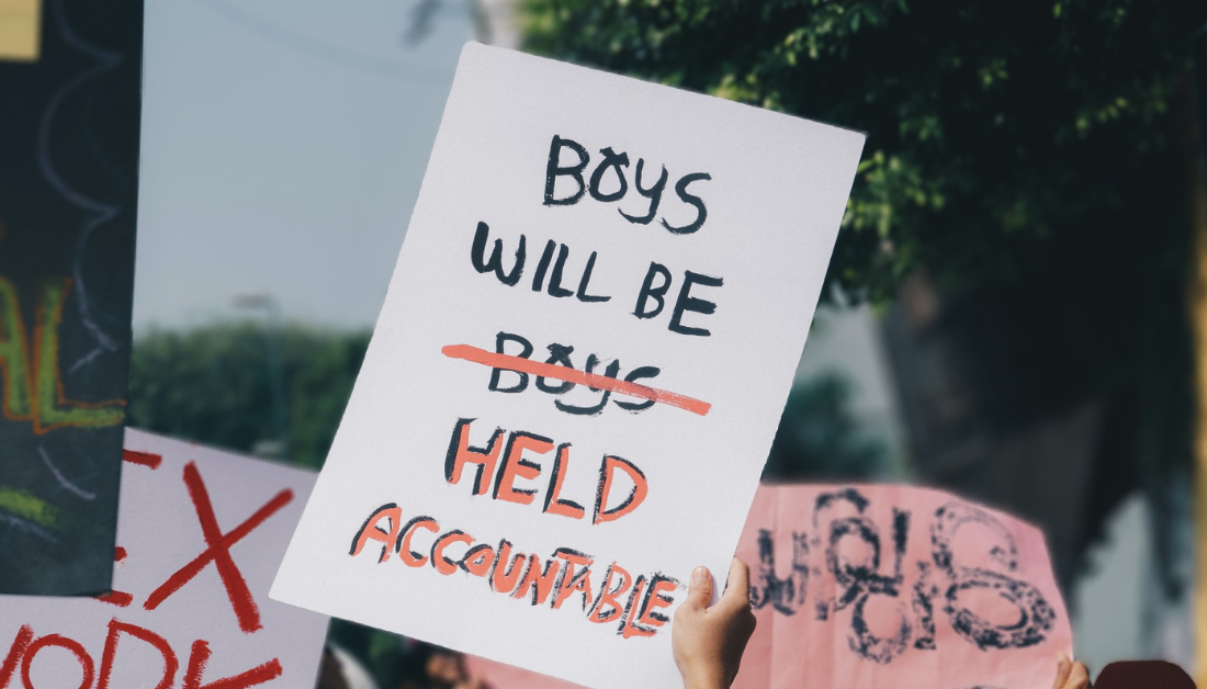 Placard that says boys will be held accountable