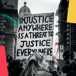 A placard that reads 'injustice anywhere is a threat to justice everywhere'