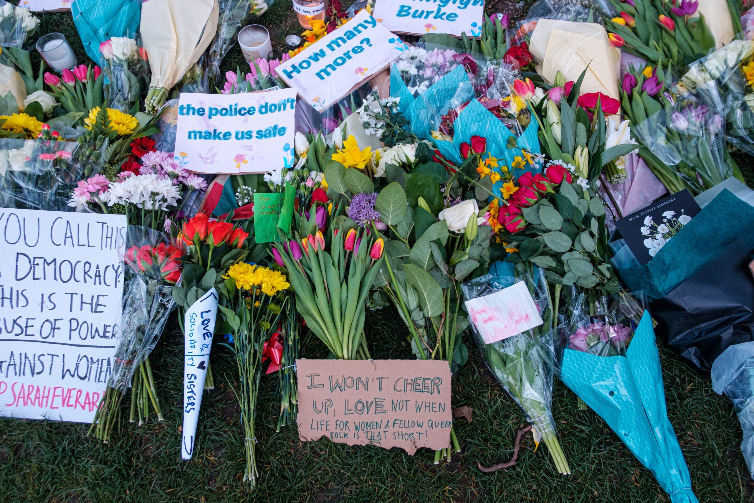 Flowers and protest signs at vigil for Sarah Everard