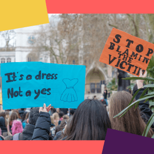 Women at a protest holding placards that read: 'it's a dress, not a yes' and 'stop blaming the victim'