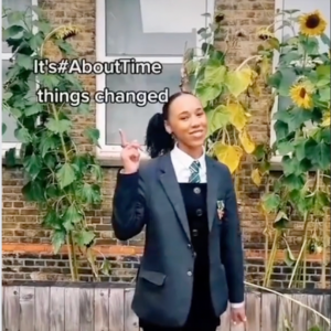 A still of a schoolgirl in a TikTok video with text that says 'It's #AboutTime things changed'