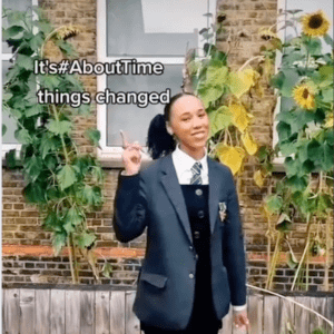 A still of a schoolgirl in a TikTok video with text that says 'It's #AboutTime things changed'