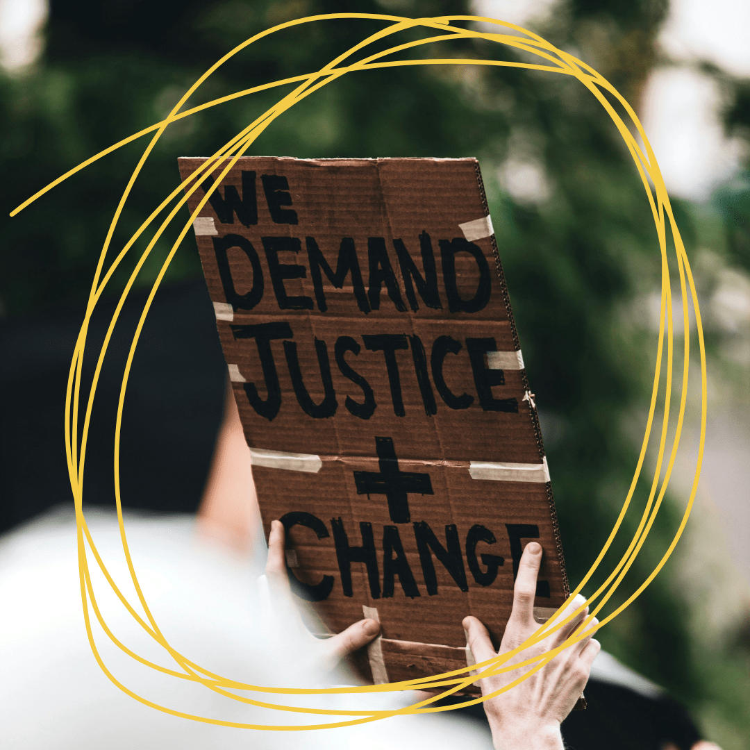 A placard that says 'we demand justice and change'