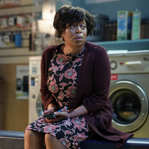 Yolande Trueman from Eastenders sitting in the laundrette