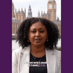 EVAW director Andrea Simon outside Parliament, with a caption that says 'a different world is possible, but it needs all of us'
