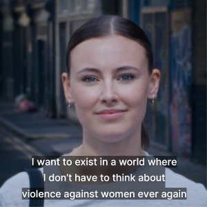 Girl looking at the camera with subtitles that say: I want to exist in a world where I don't have to think about violence against women ever again